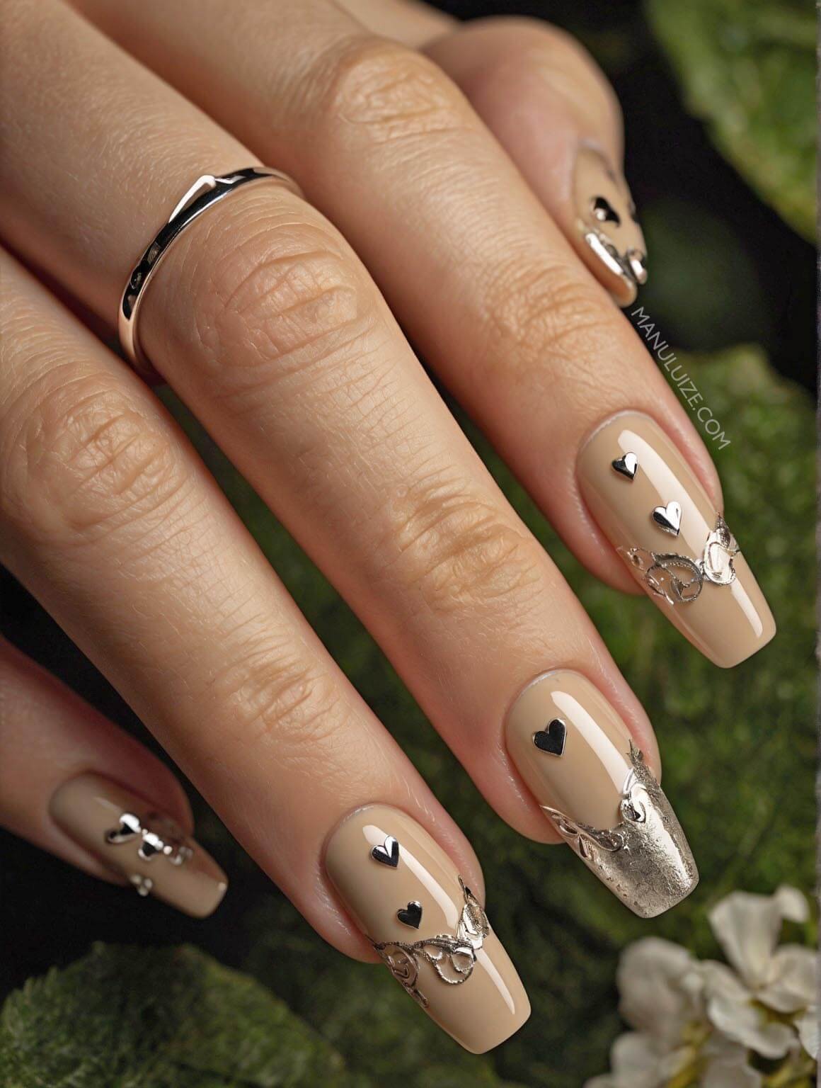 Nude nails with silver hearts