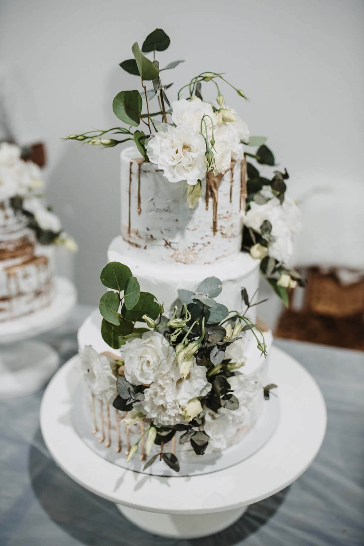 small wedding cake with flowers and greenery