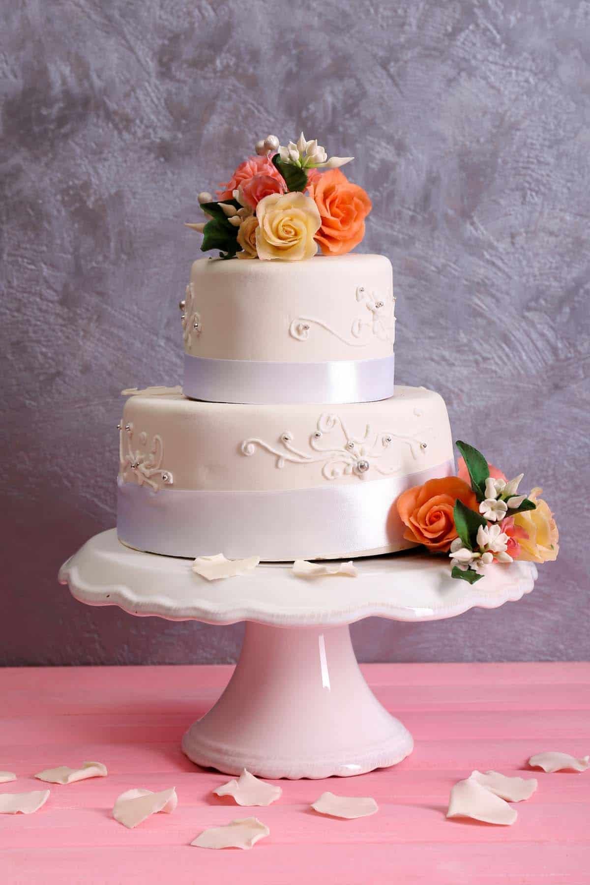 white 2 tiers cake with flowers
