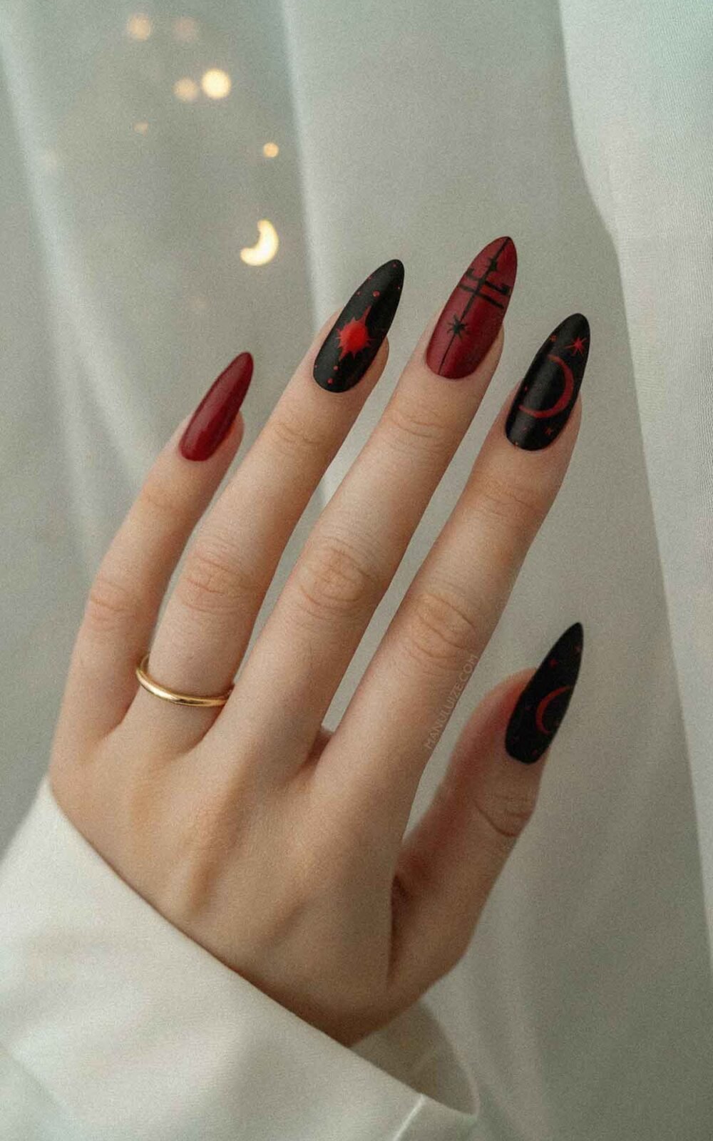 Red and black witch nail design Red and black witch nail design